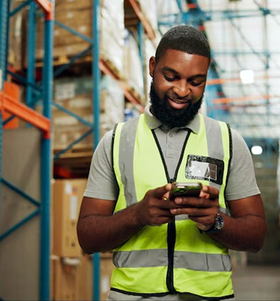 Warehouse worker using phone